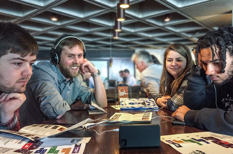 A group of visitors enjoy our temporary exhibition, Portable Sound in Cinema 1979-2000, during their visit in the lobby of the National Theatre in London, May 2018.