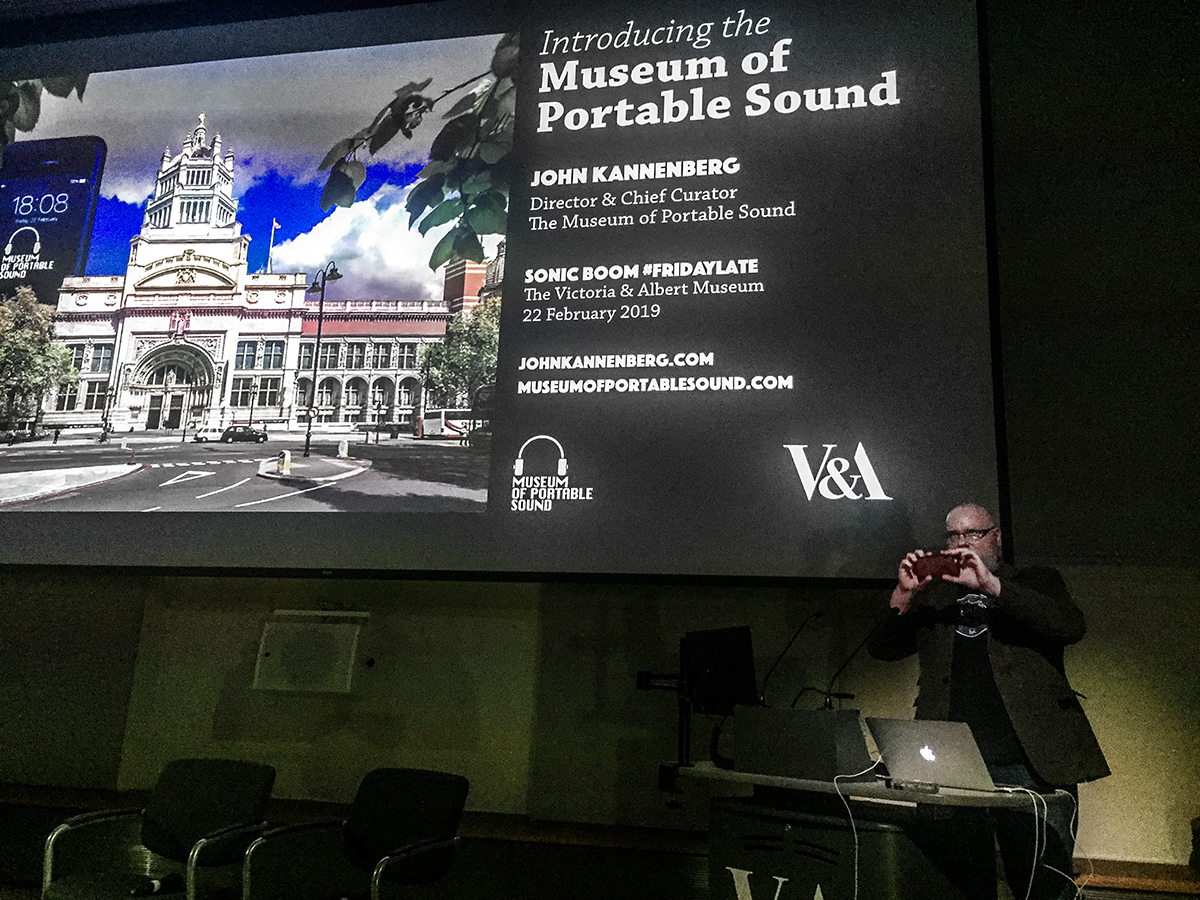 Our Director takes the stage and snaps a photo of the audience.