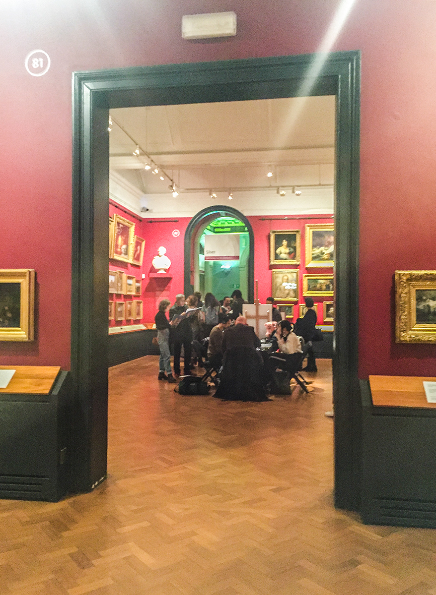 A far shot of a visit in progress from inside Room 81.