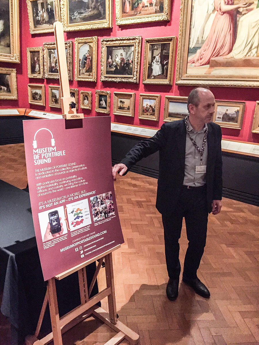 Eric de Visscher posing with the Museum of Portable Sound information display at the end of a highly successful evening!